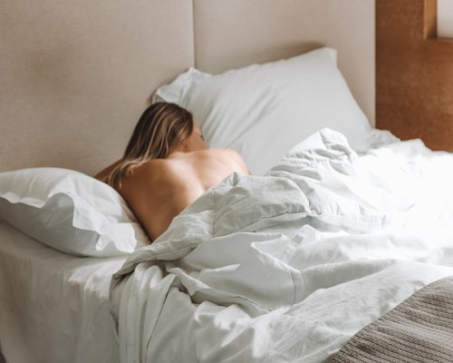 Person sleeping peacefully in a comfortable bed